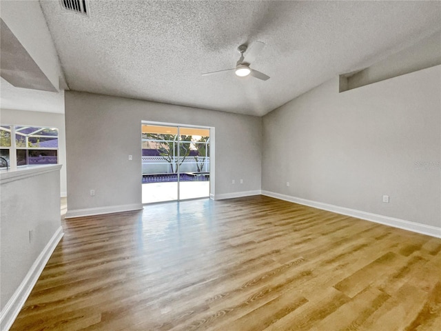 unfurnished room with wood-type flooring, a textured ceiling, and ceiling fan