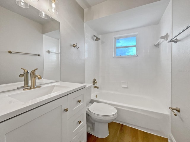 full bathroom featuring hardwood / wood-style floors, vanity, toilet, and tiled shower / bath combo