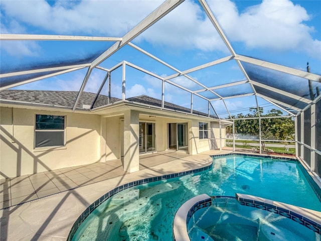 view of swimming pool featuring a lanai, an in ground hot tub, and a patio