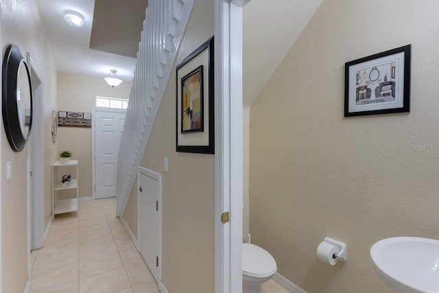 bathroom with tile patterned flooring, toilet, and sink