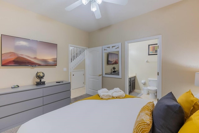 carpeted bedroom featuring connected bathroom and ceiling fan