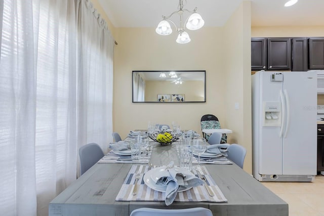 tiled dining room featuring a chandelier