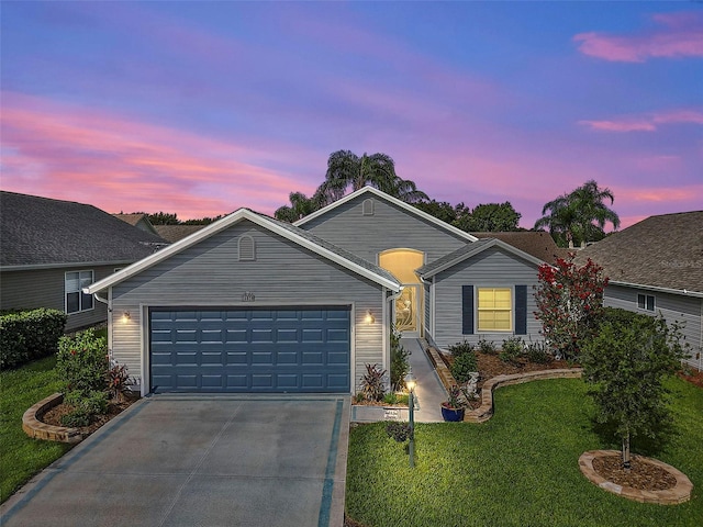 ranch-style house featuring a yard and a garage