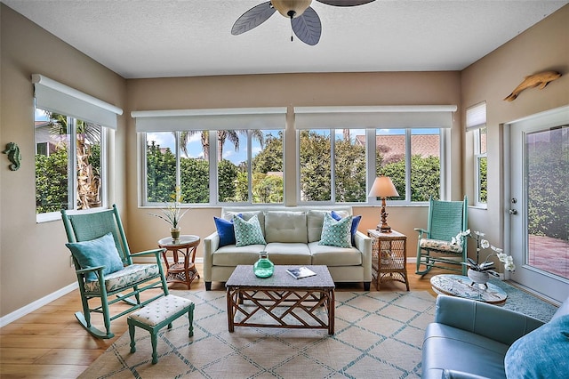 sunroom with ceiling fan and plenty of natural light