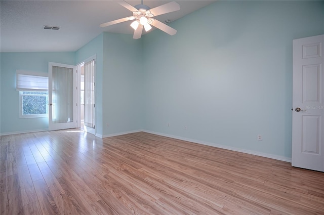 spare room featuring vaulted ceiling, ceiling fan, and light hardwood / wood-style floors