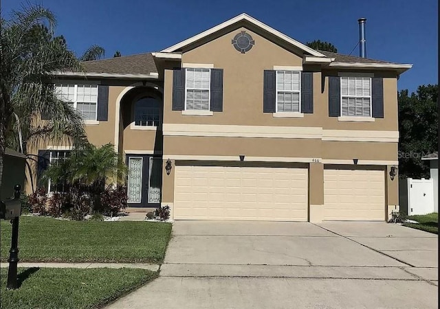 view of front of property with a garage and a front yard