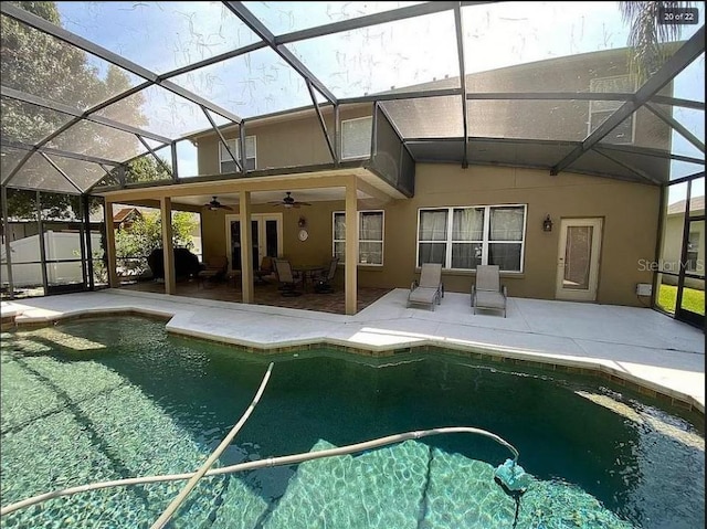 view of pool featuring a lanai, ceiling fan, a fenced in pool, and a patio