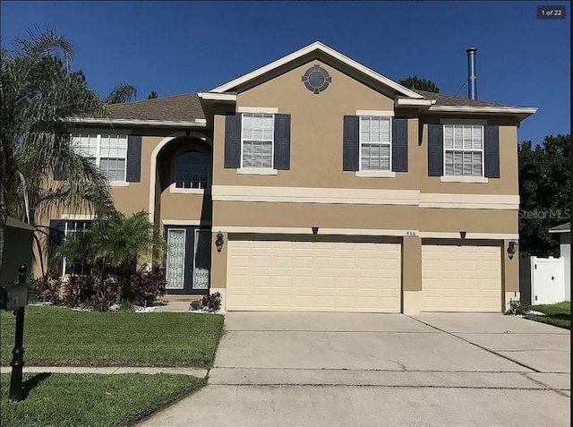 view of front of house featuring concrete driveway, an attached garage, and stucco siding