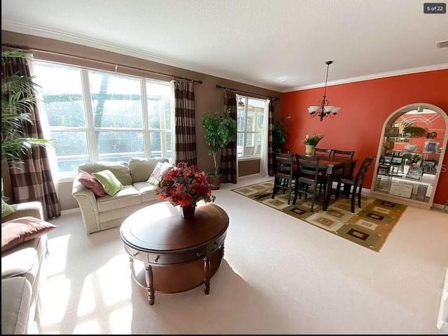 carpeted living area with a notable chandelier, a textured ceiling, visible vents, and crown molding