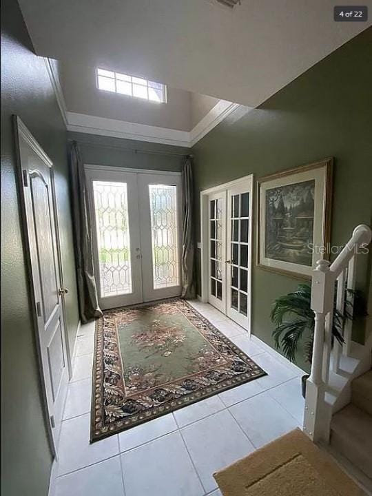 doorway with stairs, french doors, and light tile patterned floors