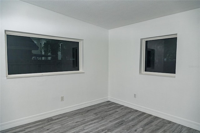 empty room with hardwood / wood-style flooring