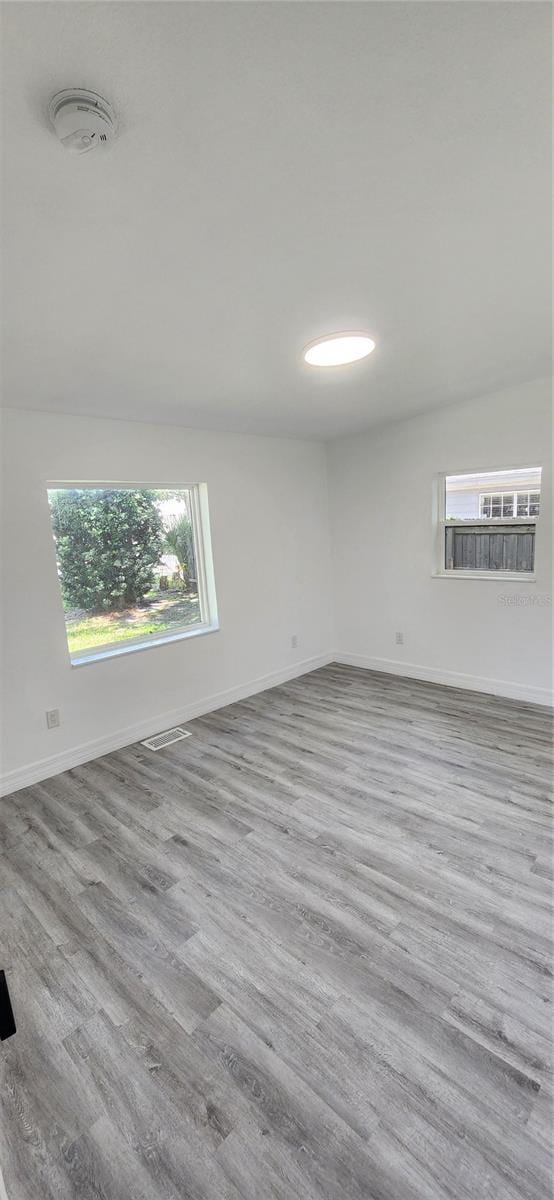 spare room with hardwood / wood-style floors