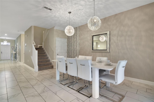 dining space with a chandelier