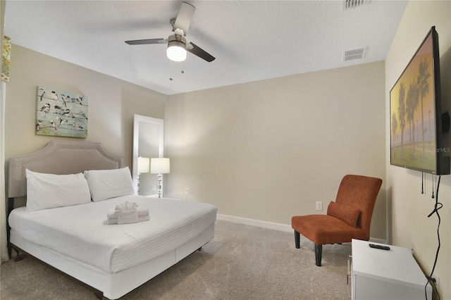 sitting room featuring carpet, ceiling fan, and a textured ceiling