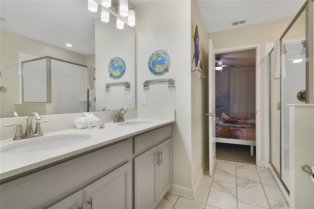 bathroom featuring ceiling fan, vanity, and a shower with door