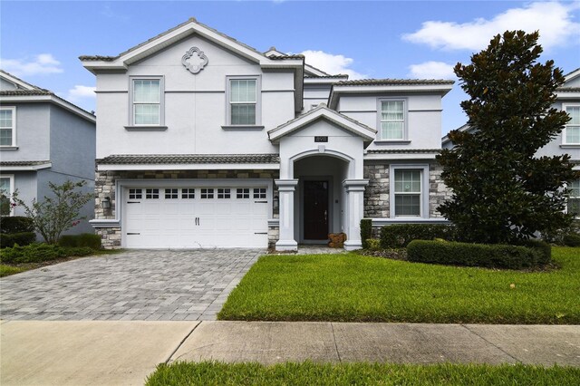 view of property with a front yard and a garage