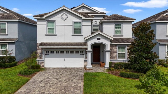 view of front facade with a front yard and a garage