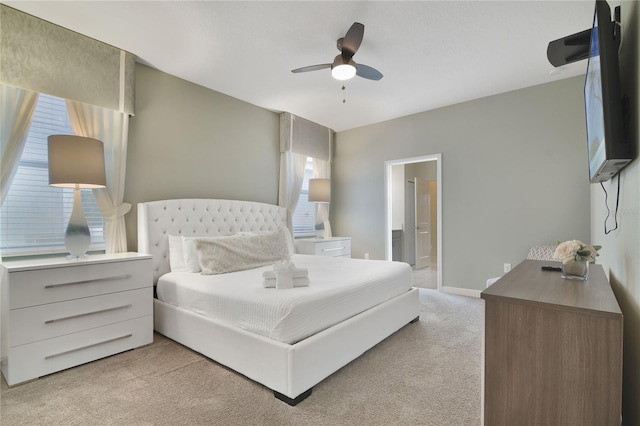 carpeted bedroom featuring ceiling fan and ensuite bathroom