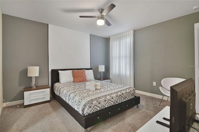 bedroom featuring light carpet and ceiling fan