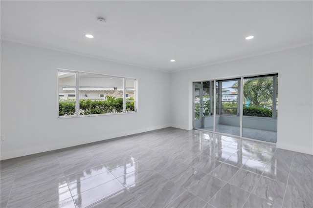 spare room with plenty of natural light, light tile flooring, and crown molding