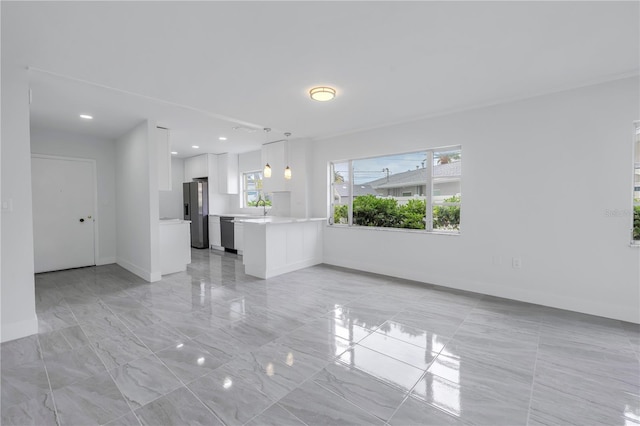 unfurnished living room featuring sink and light tile floors