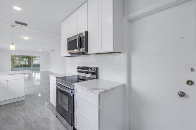 kitchen with backsplash, light tile floors, hanging light fixtures, range with electric stovetop, and white cabinetry