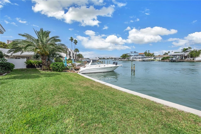 dock area with a lawn and a water view