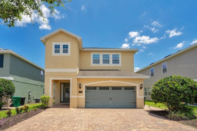 view of front of home featuring a garage and central AC unit