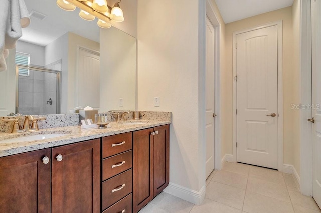 bathroom with double sink vanity and tile patterned flooring