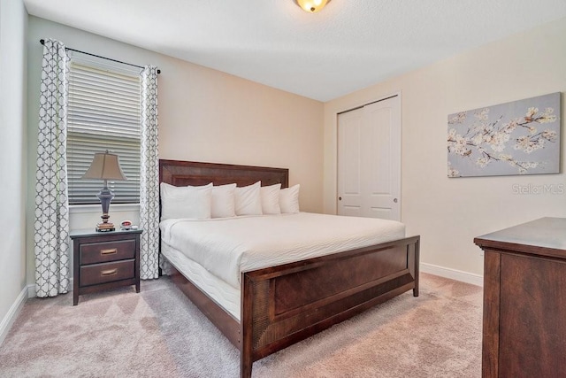 carpeted bedroom featuring a closet