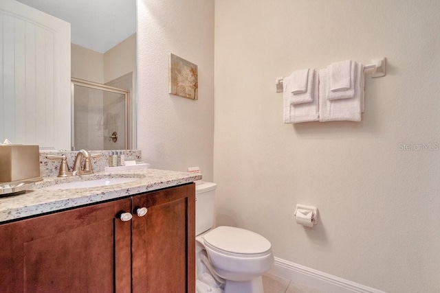 bathroom with vanity, tile patterned flooring, and toilet