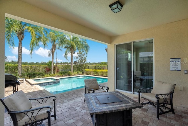 view of pool featuring a patio and an in ground hot tub