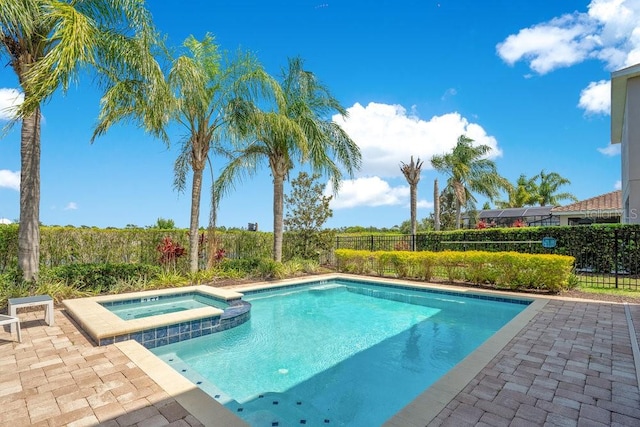 view of pool featuring an in ground hot tub and a patio