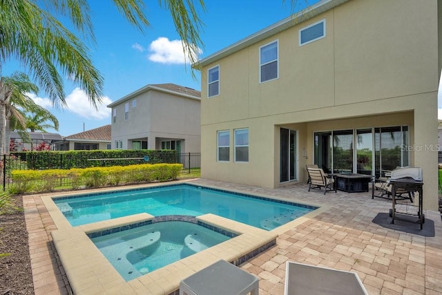 view of swimming pool with a patio area and an in ground hot tub