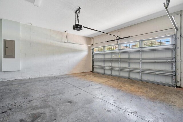 garage featuring a garage door opener and electric panel