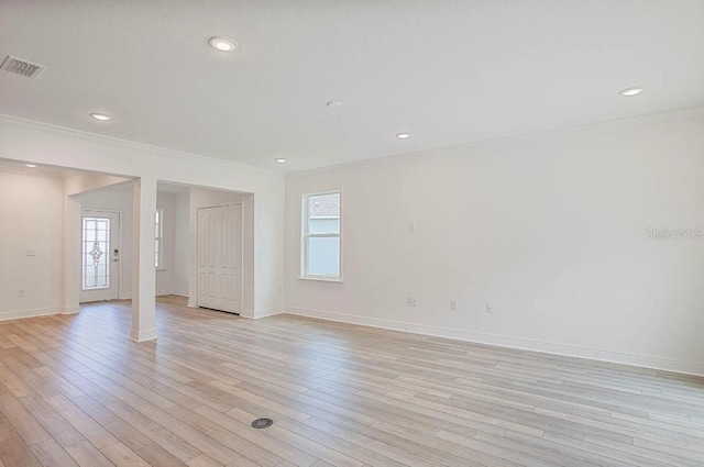 spare room with crown molding and light hardwood / wood-style floors