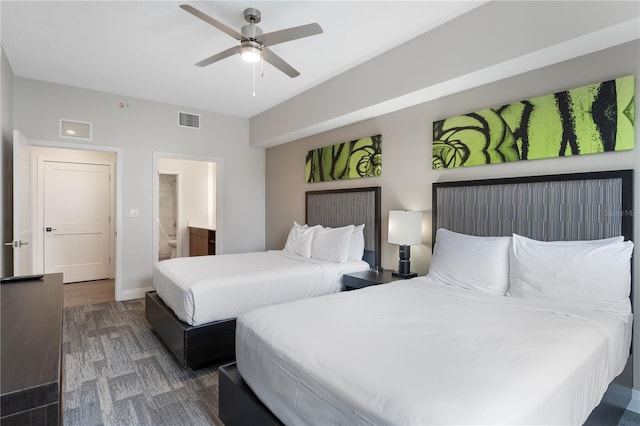 bedroom with connected bathroom, ceiling fan, and dark wood-type flooring