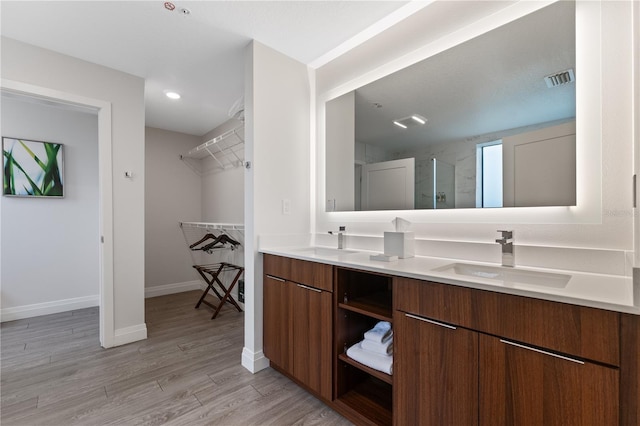 bathroom with vanity, hardwood / wood-style flooring, and an enclosed shower