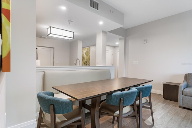 dining area featuring sink and light hardwood / wood-style floors