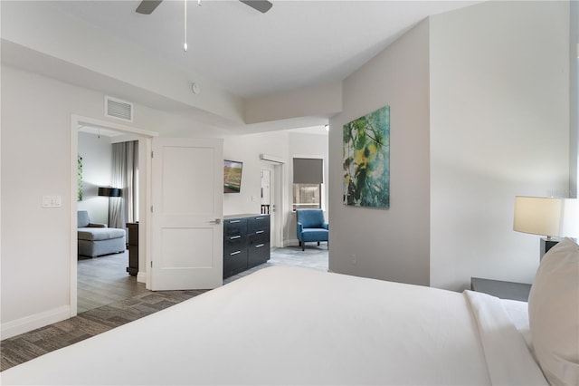 bedroom with ceiling fan and dark wood-type flooring