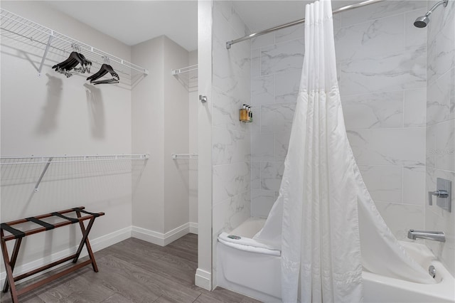 bathroom featuring wood-type flooring and shower / tub combo