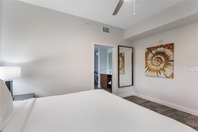 bedroom featuring ensuite bath, ceiling fan, and dark hardwood / wood-style floors