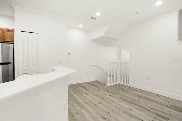 interior space featuring light hardwood / wood-style flooring and ornamental molding