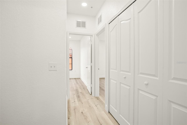 hall with light hardwood / wood-style floors