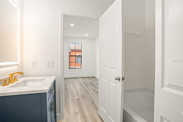 bathroom with hardwood / wood-style floors and vanity