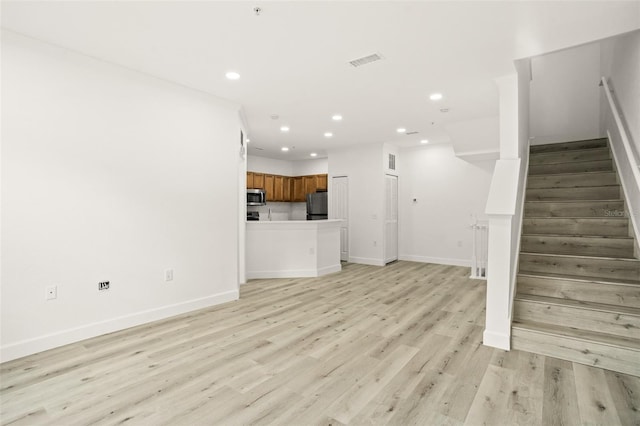 unfurnished living room featuring light hardwood / wood-style flooring