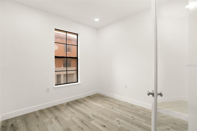 unfurnished room with light hardwood / wood-style floors and french doors