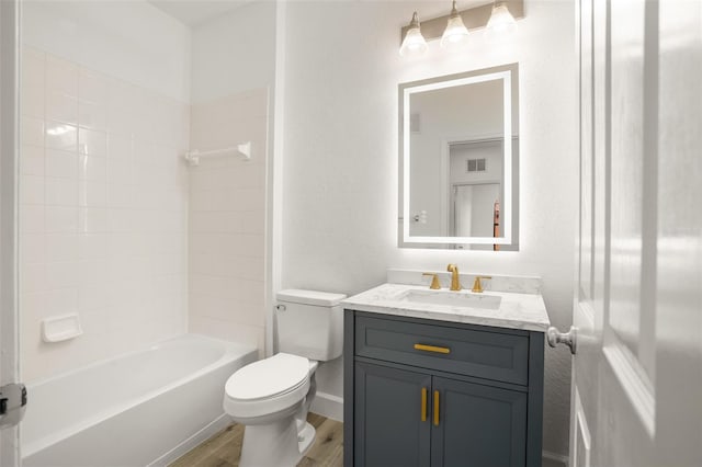 full bathroom featuring hardwood / wood-style floors, vanity, toilet, and shower / bathtub combination