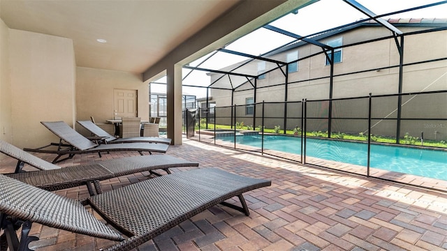 view of swimming pool featuring a lanai and a patio area