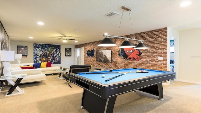 game room with ceiling fan, brick wall, light colored carpet, a textured ceiling, and pool table